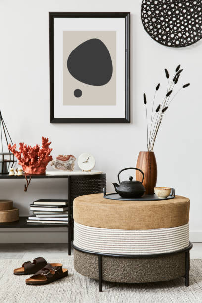 istock Stylish living room interior composition with mock up poster frame, pouf, console and elegant personal accessories. Copy sapce. Template. 1356354347
