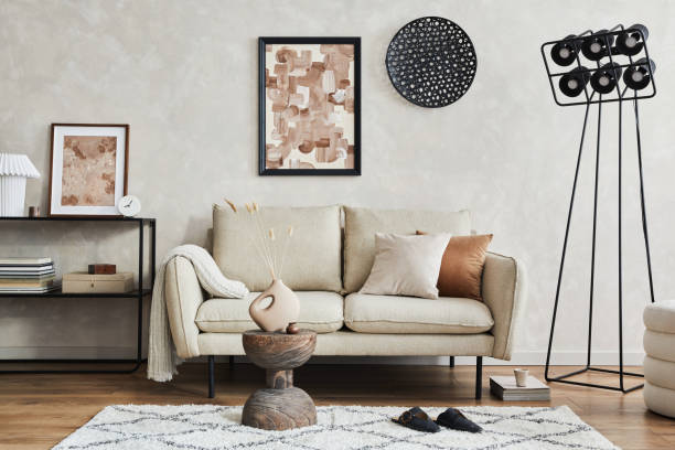 istock Elegant living room interior composition with beige sofa, black console, coffee table, pouf, mock up poster frame and creative design personal accessories. Copy space. Template. 1356355369