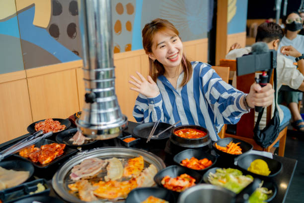 istock Vlogger is sharing food in famous restaurants. 1356356533