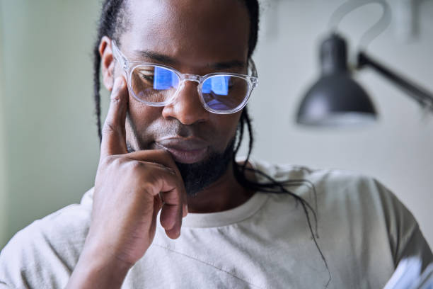 istock Bearded man relaxing on sofa while reading breathtaking book at his apartment 1356356578