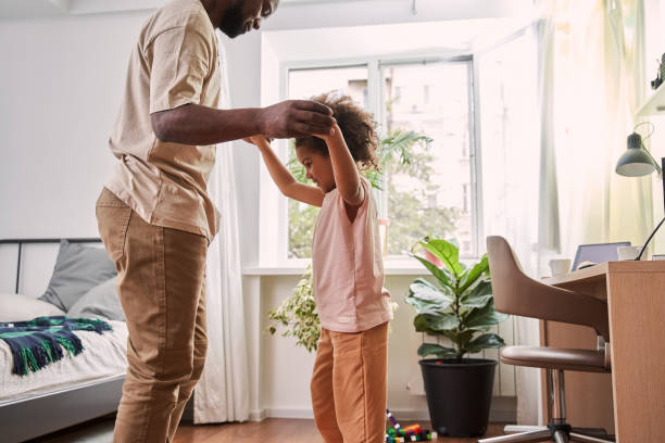 istock Happy father is holding hands with his little daughter 1356357232