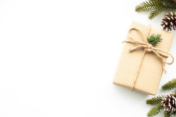 istock Beautiful Christmas background with gift box, decorate with pine branch and pine cone over white background. Top view with copy space, flay lay. 1356358568