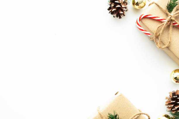 istock Beautiful Christmas background with gift boxes, decorate with pine branch and pine cone over white background. Top view with copy space, flay lay. 1356358600