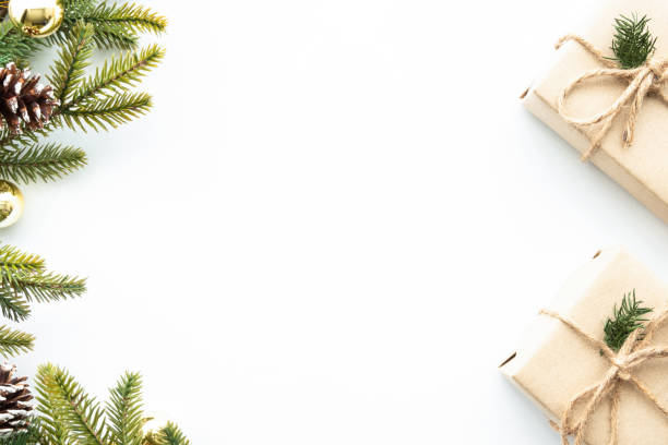 istock Beautiful Christmas background with two gift boxes, decorate with pine branches and golden balls over white background. Top view with copy space, flay lay. 1356358688