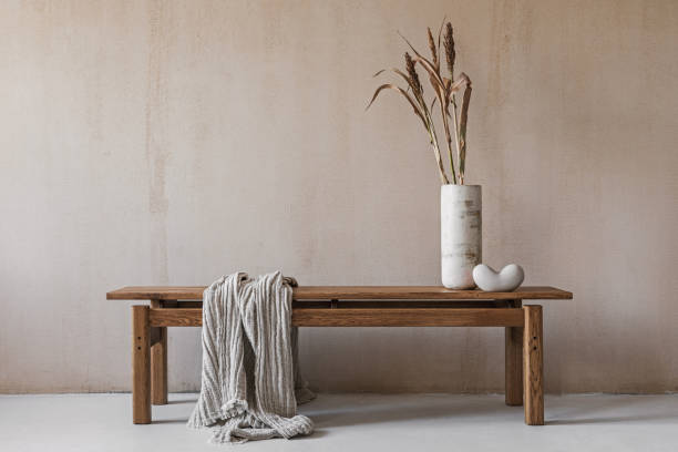 istock Creative composition with elegant wooden bench. Beautiful decorations and accessories. Modern home interior design. Retro inspiration. Copy space. Structure wall. Template. 1356358787