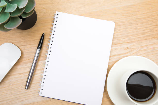 istock open notepad, cup of coffee, pen ,moose on wooden background spiral notebook on table Business, planning, education, morning life working from home concept Top view Flat lay Mock up 1356360903
