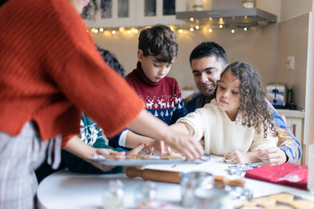 istock Sister and brothers making Christmas gingerbread cookies 1356361386