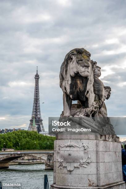 Statue Of A Lioin On Bridge Alexandre Iii View To Eiffel Tower Paris Stock Photo - Download Image Now