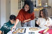 istock Sister and brother making Christmas gingerbread cookies with a mother 1356361463