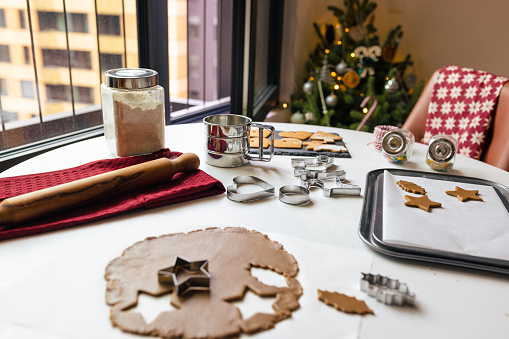 cutting dough with christmas tins