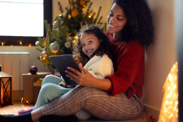 istock Mother and daughter having Christmas video call 1356361870