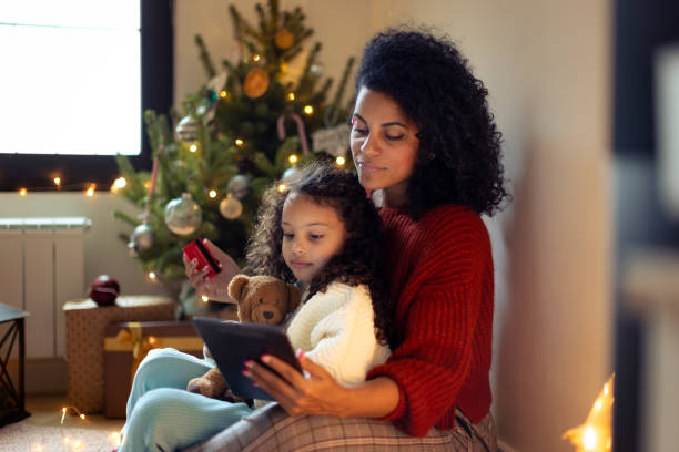istock Mother and daughter having Christmas video call 1356361905