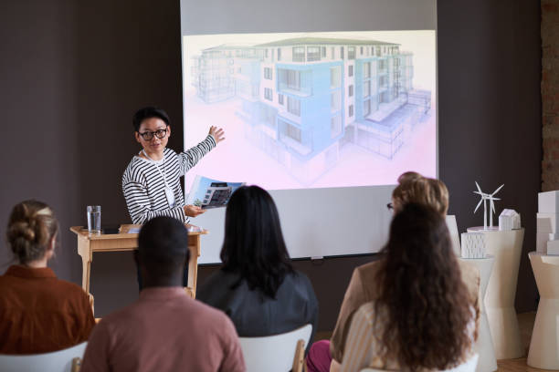 istock Young man presenting his report at seminar 1356362546