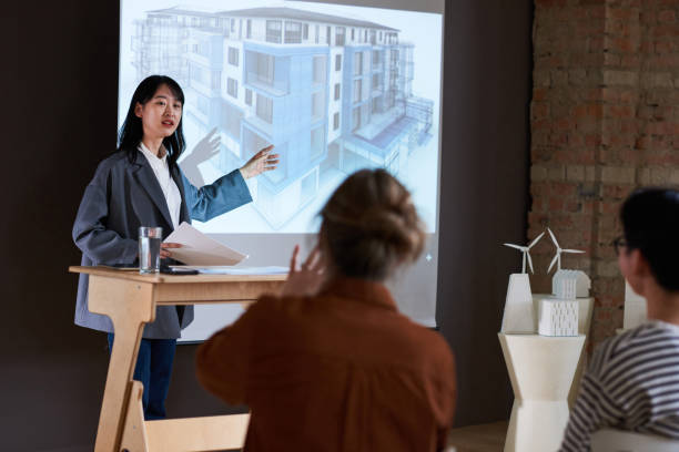 istock Woman talking about architectural blueprint 1356362558