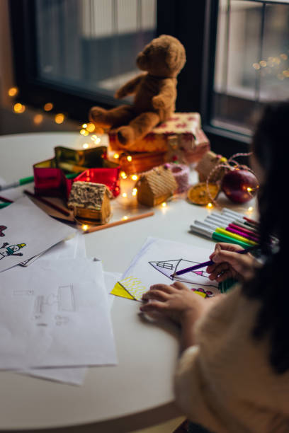 istock Girl drawing a Christmas wish list 1356362585