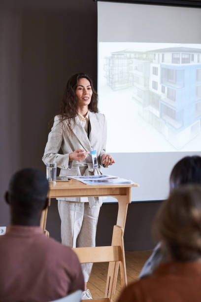 istock Businesswoman performing at seminar 1356362592