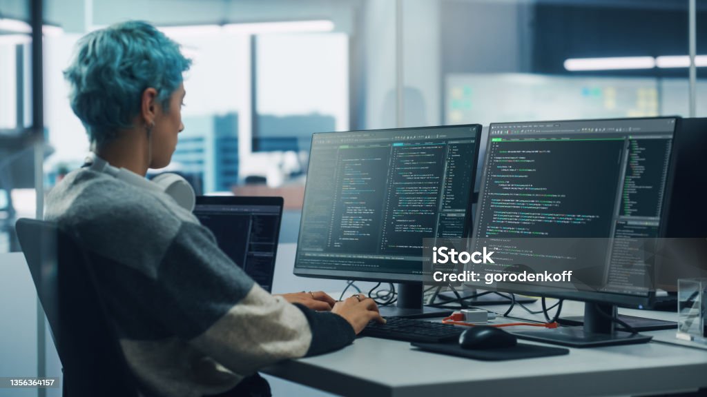 In Diverse Office Female Programmer Is Working On Desktop Computer ...
