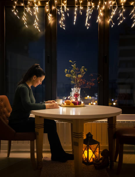 istock Woman reading book at a Christmas night 1356364707