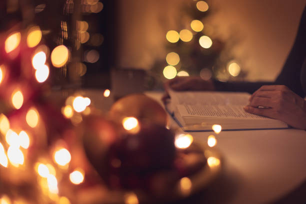 istock Tea, book and defocused Christmas lights 1356364723