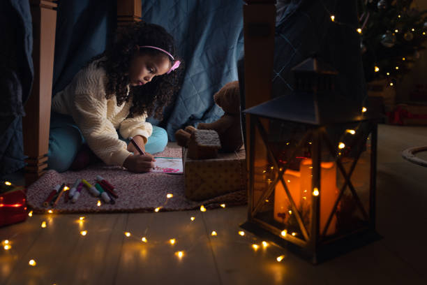 istock Girl writing a Christmas wish list 1356364867