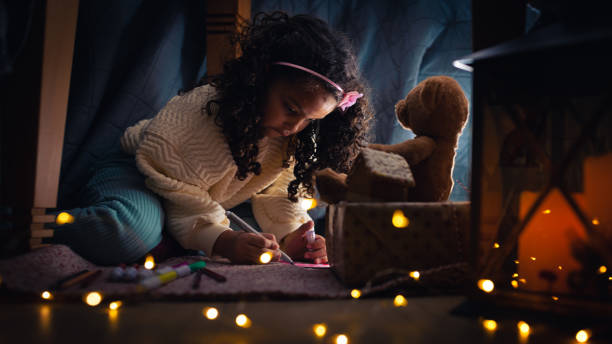 istock Girl writing a Christmas wish list 1356364870