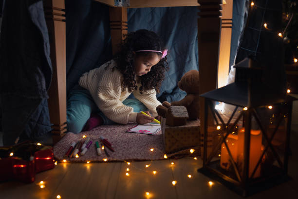 istock Girl writing a Christmas wish list 1356364897