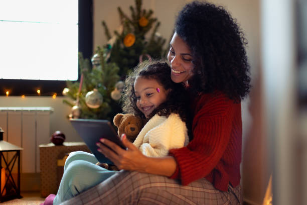 istock Mother and daughter having Christmas video call 1356364944