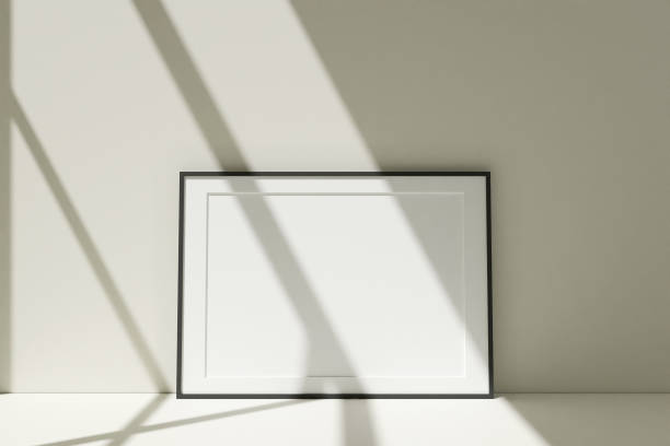 istock Horizontal black photo frames mockup on the floor leaning against the room wall with shadow. 3D Rendering. 1356366019