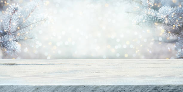 istock Wood table top on  christmas tree background 1356367373