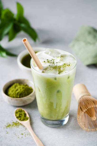 Matcha ice latte in a glass Matcha ice latte in a glass on grey concrete table background. Healthy trendy vegan drink japanese food photos stock pictures, royalty-free photos & images