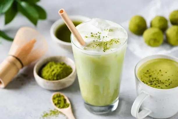 Delicious Vegan Matcha Ice Latte In Glass On Grey Stone Background Closeup View