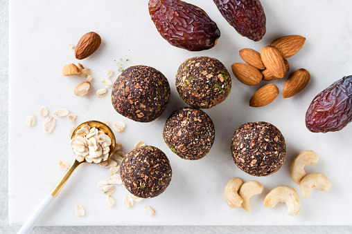 Homemade vegan raw truffles, energy balls with dates, nuts and oats. Top view