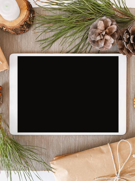 istock Christmas decorations and blank digital tablet on table, background, mockup 1356369408