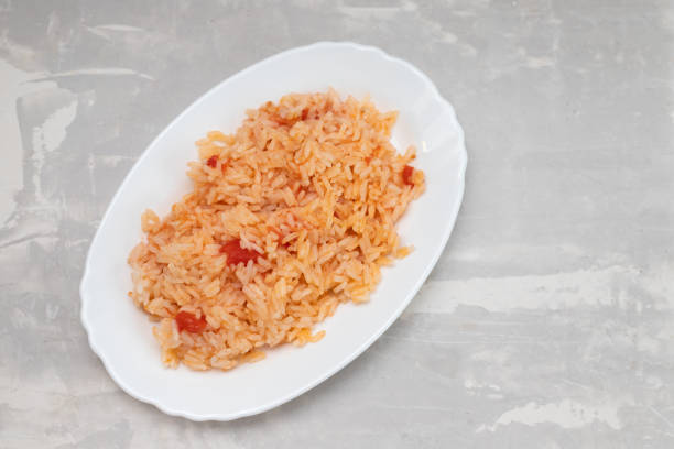 istock boiled rice with tomato and spices on white dish 1356371851
