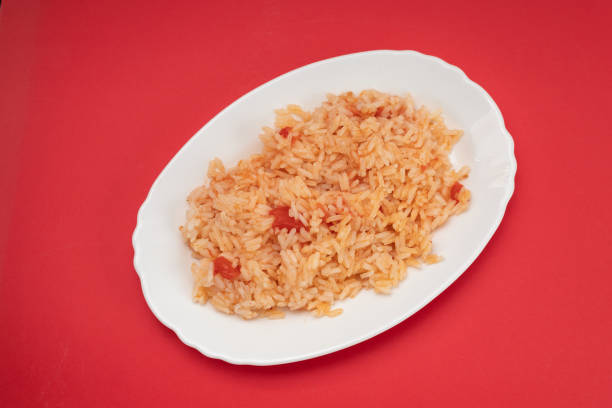 istock boiled rice with tomato and spices on white dish 1356371865