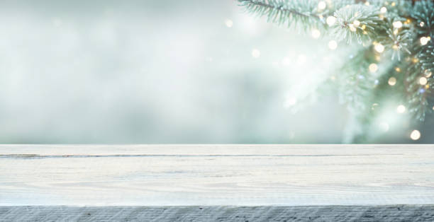 istock Wood table top on  christmas tree background 1356372483