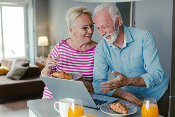 istock Senior couple using laptop at home 1356372958