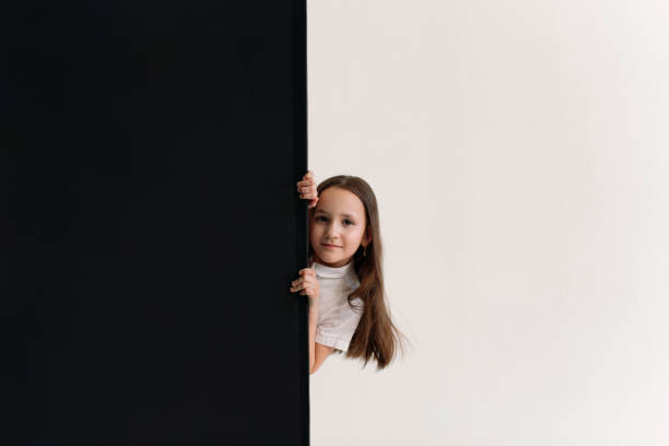 istock she looks out from behind a black wall 1356373023