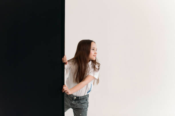 istock she looks out from behind a black wall 1356373044