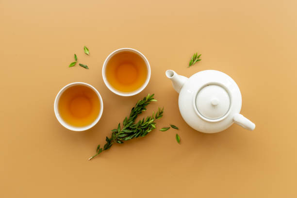 istock Tea drinking with white teapot and black tea in two cups 1356373869