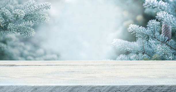 istock Wood table top on  christmas tree background 1356374008