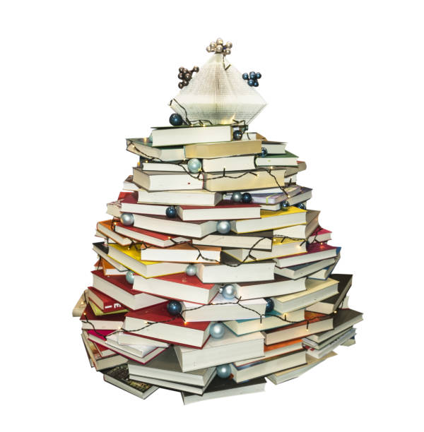 istock Christmas tree made of books on white background 1356374019