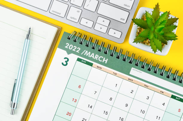 March 2022 desk calendar and diary with keyboard March 2022 desk calendar and diary with keyboard computer on yellow background. march month photos stock pictures, royalty-free photos & images