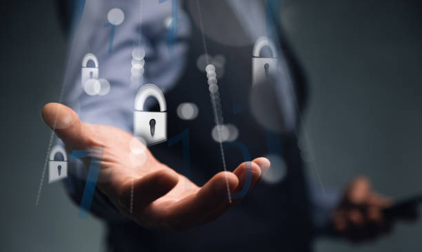 istock businessman holding a mobile phone with mobile security concept 1356377317