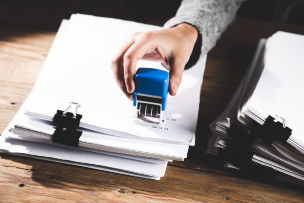 istock woman holding seal and documents 1356377376