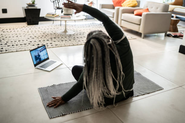 istock Senior woman doing an online exercise class at home 1356377469