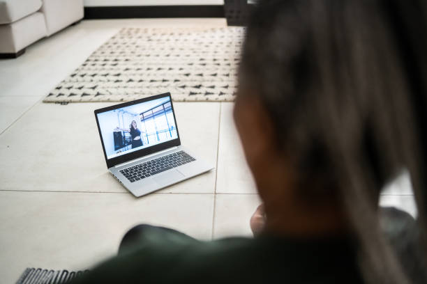istock Senior woman doing an online exercise class at home 1356377584