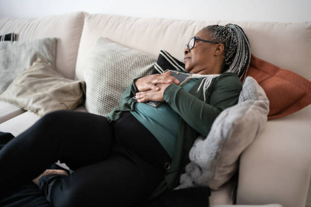 istock Senior woman holding a picture frame missing someone at home 1356378186