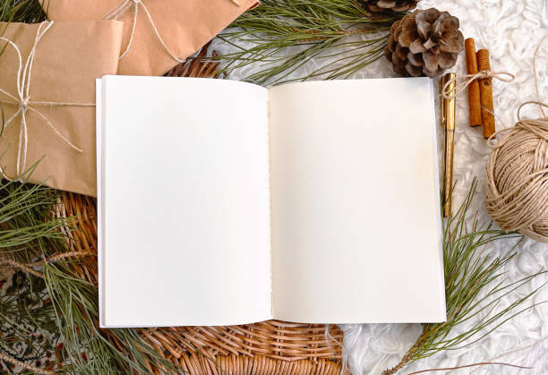 istock Christmas decorations and blank vintage notebook on table, background, mockup 1356378308