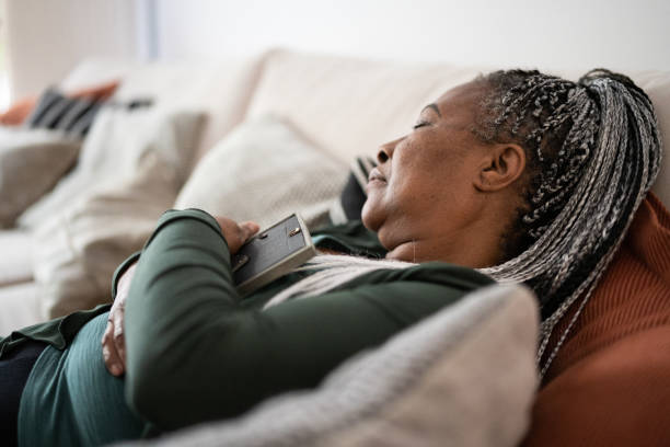 istock Senior woman holding a picture frame missing someone at home 1356378391